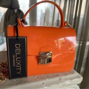 Deluxity Los Angeles orange jelly crossbody with gold chain.
